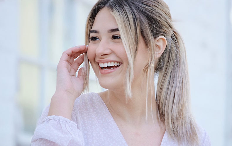 Patient smiling after a comfortable and personalized dental visit.